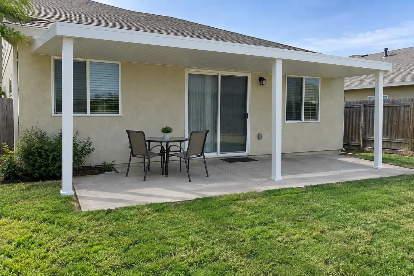 A white aluminium patio cover rendered over a homeowner's back patio