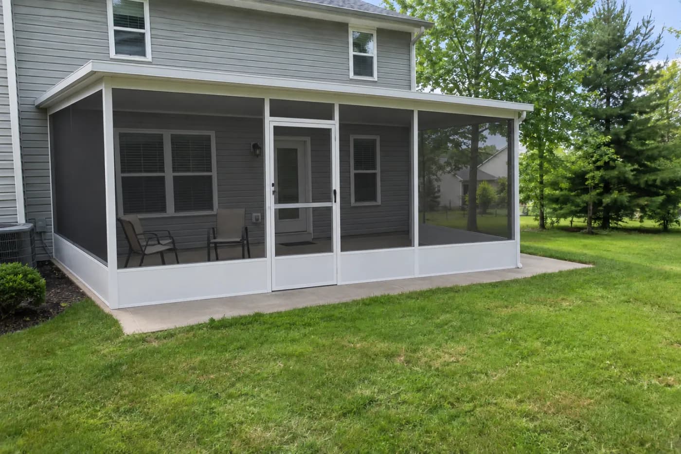 A screened patio enclosure rendered onto a homeowner's back patio